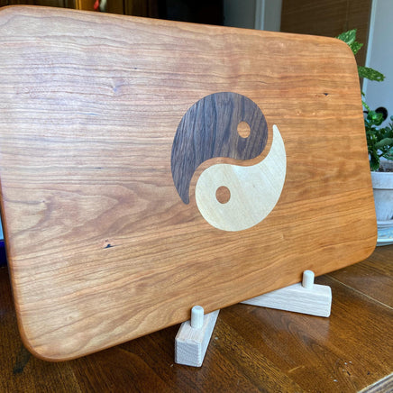 Cherry charcuterie board with Yin Yang inlay made from Peruvian Walnut and Maple.