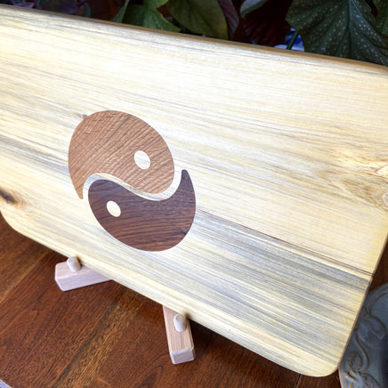 Poplar charcuterie board with Yin Yang inlay made from White Oak and Peruvian Walnut.