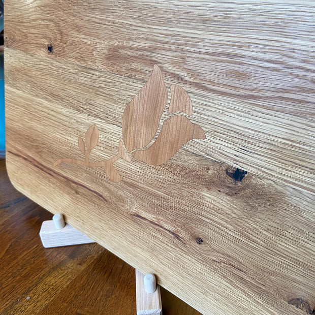 White Oak charcuterie board with subtle rose and stem inlay made from Cherry.